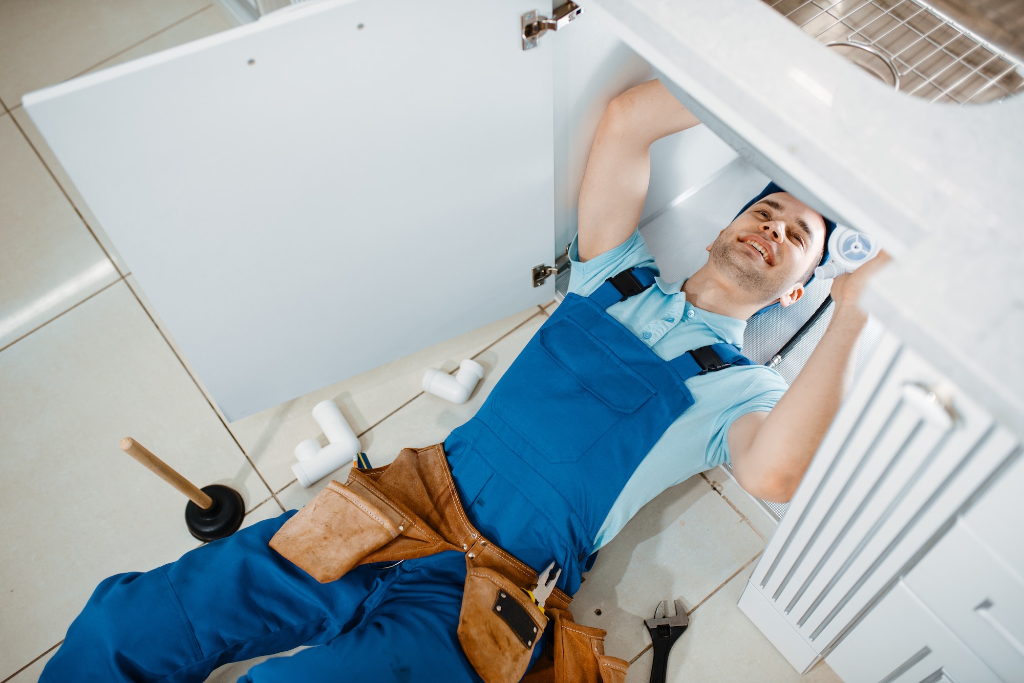 plumber-in-uniform-installing-drain-pipe-top-view.jpg