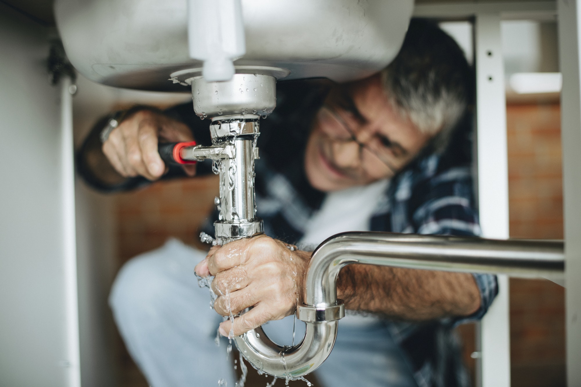 plumber-fixing-the-kitchen-sink.jpg